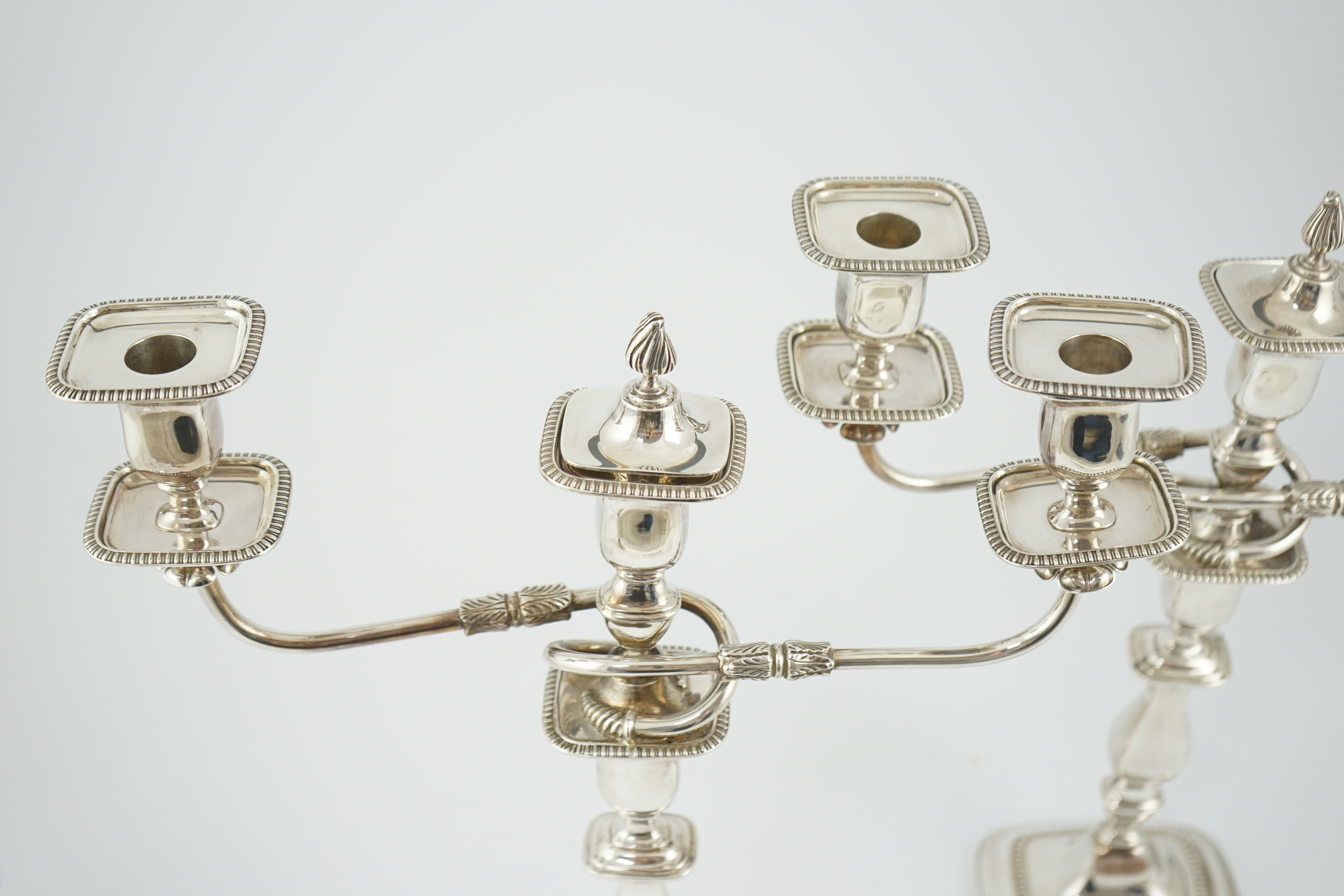 A pair of Elizabeth II silver two branch two light candelabra, by James Dixon & Sons